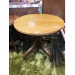 A circular top conservatory occasional table.