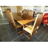 A reproduction oak refectory table and set of eight (6 + 2) oak panel back dining chairs on