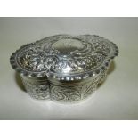 A lobed silver trinket box with embossed decoration and engraved cartouche lynda