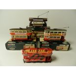 Four motorised  Corgi Trams, converted to 00 gauge, three boxed in the liveries of London Transport,