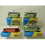 Four motorised Corgi Trams, boxed and converted to 00 gauge use,