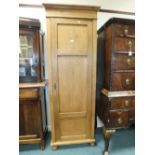 An Edwardian pine single livery or linen cupboard