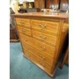 An Edwardian inlaid mahogany tall boy type chest of four short over three long drawers