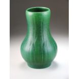 A Pilkington's Royal Lancastrian vase with a mottled green ground subtly decorated with leaves,