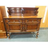 An Edwardian oak sideboard in the Jacobean style with geometric drawer and door fronts