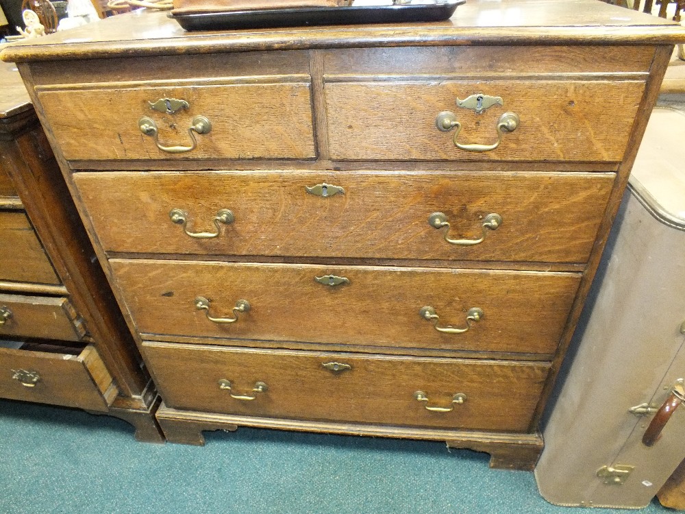 A 19th century oak chest of two short over three long drawers raised on bracket feet.