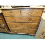 A 19th century oak chest of two short over three long drawers raised on bracket feet.