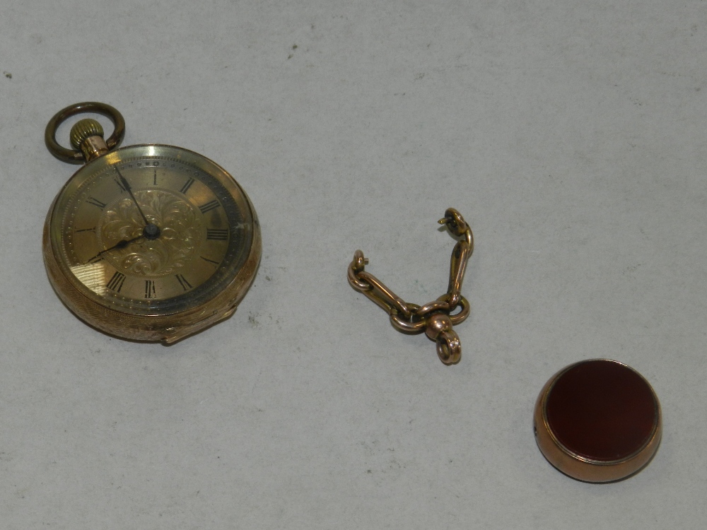 A ladies yellow metal continental fob watch together with a hard stone set seal