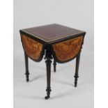 A late 19th century Aesthetic figured walnut and ebonised drop leaf centre table with central