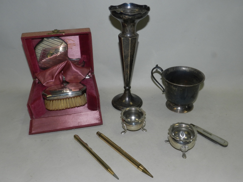 A cased three piece silver mounted travelling dressing table set, pair of salts,