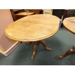 A 20th century oak pedestal dining table