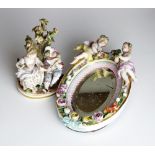 A small Hochst porcelain group of a male musician and a female seated barefoot before a tree,
