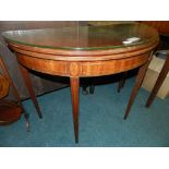An Edwardian inlaid mahogany fold over demi lune table