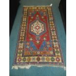 A 20th century blue red and cream ground Persian design rug (at fault)