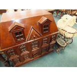 A large mahogany doll's house and four doll's prams