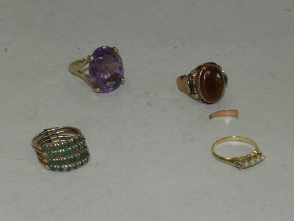 An amethyst set dress ring together with a seed pearl set ring lacking one pearl,