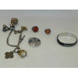 A collection of hard stone set fobs, a white metal and niello work brooch,