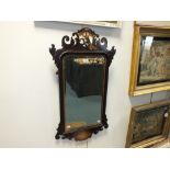 A George II style pierced fret work mirror the bevelled plate framed with an ogee border,