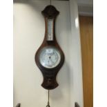 An early 20th century oak cased aneroid banjo barometer