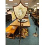 A 19th century mahogany pole screen the shield panel with wool work and silk scene of a rustic