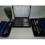 A cased three piece silver christening set comprising knife, fork and spoon, a silver vase,