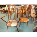 A set of six reproduction spindle back dining chairs comprising two carvers and four plain chairs
