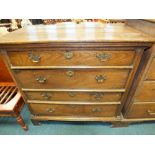 A 19th century chest of four long drawers raised on bracket feet