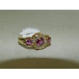 A 18ct gold diamond and purple stone set cluster ring