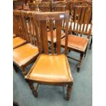 A set of four Edwardian oak dining chairs