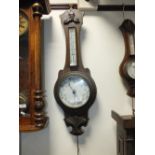 An Edwardian oak cased banjo aneroid barometer