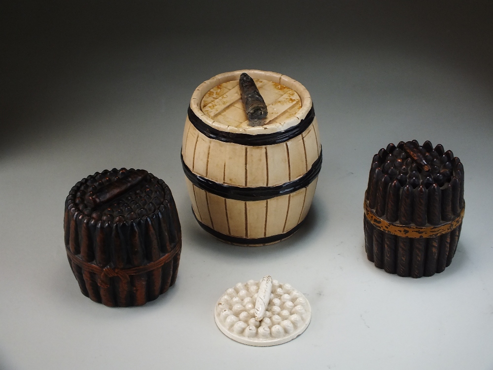 Three Victorian pottery cigar boxes and covers, including a Bretby example, each of barrel shape,