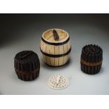 Three Victorian pottery cigar boxes and covers, including a Bretby example, each of barrel shape,