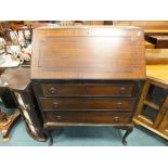 An early 20th century reproduction mahogany bureau