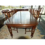 A mahogany wind-out extending dining table,