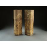 A pair of Chinese bamboo vases, 20th Century, of natural form and carved with landscape scenes,