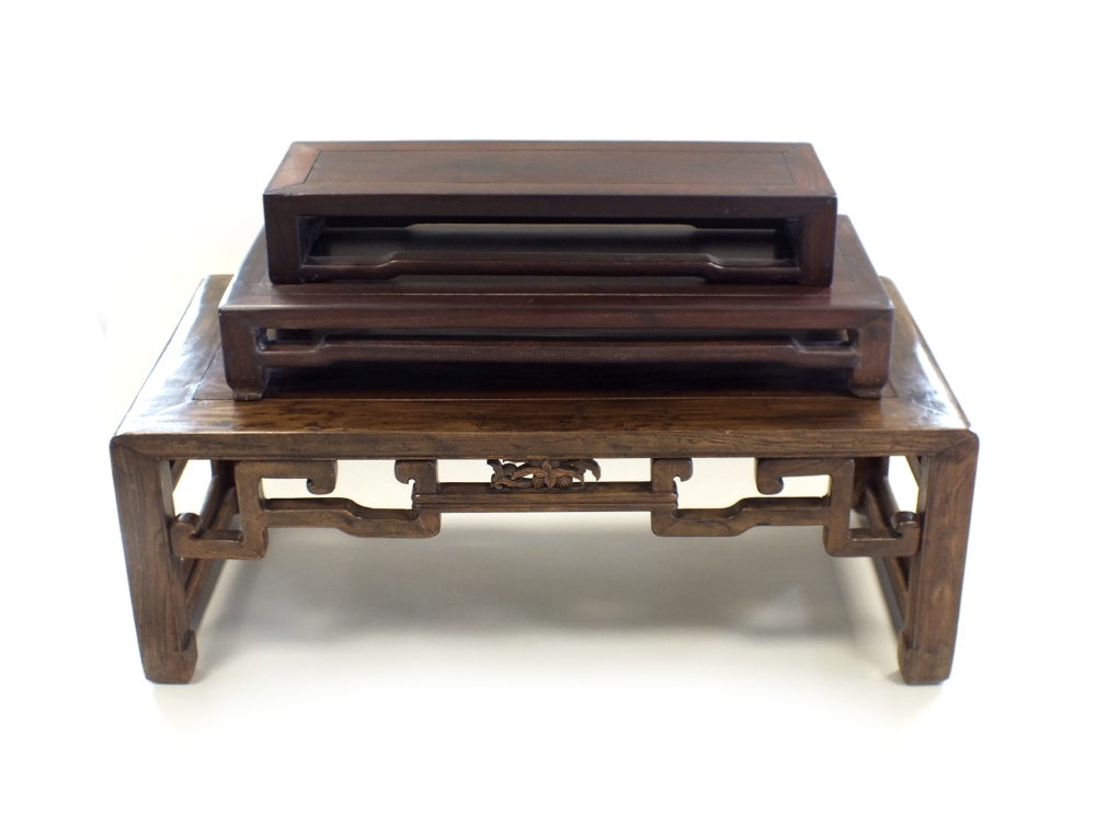 A Chinese hardwood low table, 20th Century, of rectangular outline with rounded ends,