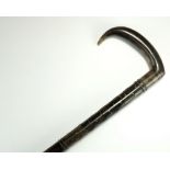 A mixed horn inlaid walking stick, probably Indian, the L-shaped head above a tapering stick,