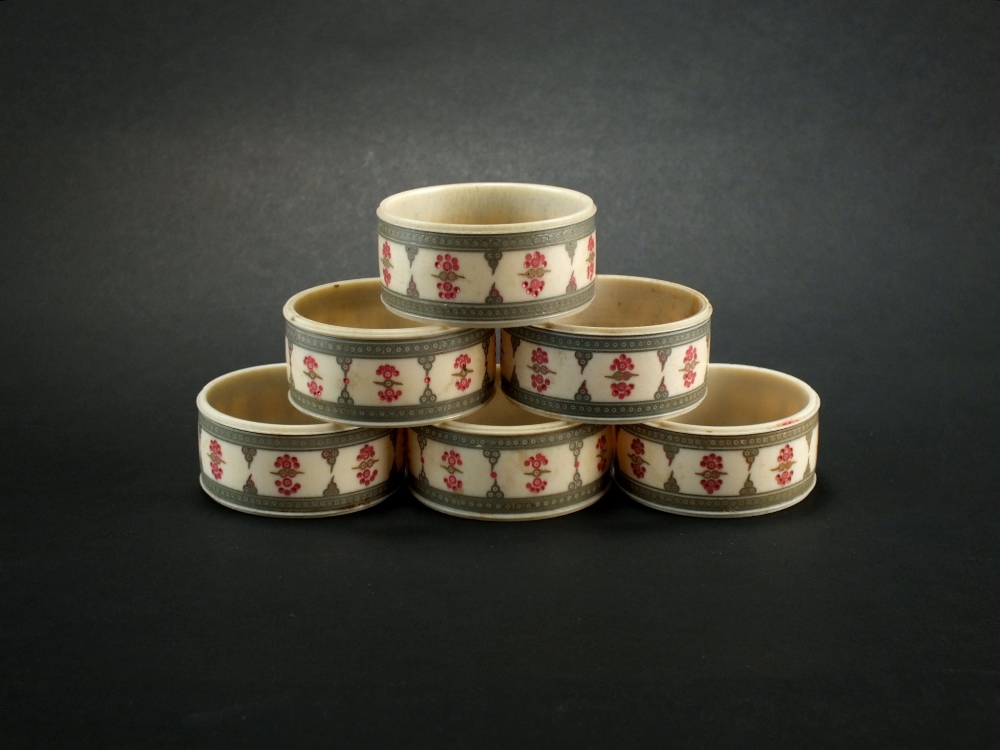 A set of six Indian stained ivory napkin rings, worked with stylised flower borders, 5cm dia.
