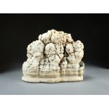 An aragonite scholar's rock, the white and orange-hued stone of horizontal orientation, 24cm high,