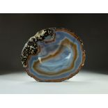 A banded agate polished geode slice, dished to the centre, 27x23cm.
