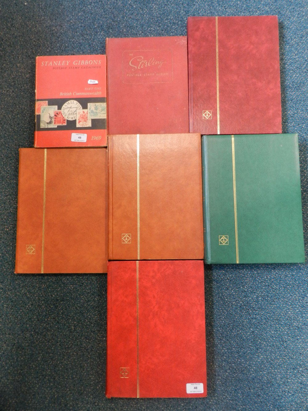 Six albums of British Commonwealth and foreign stamps and a 1969 catalogue.