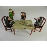 A chimpanzee Tea Party comprising 3 chairs, table, 2 plates with food, and keeper,