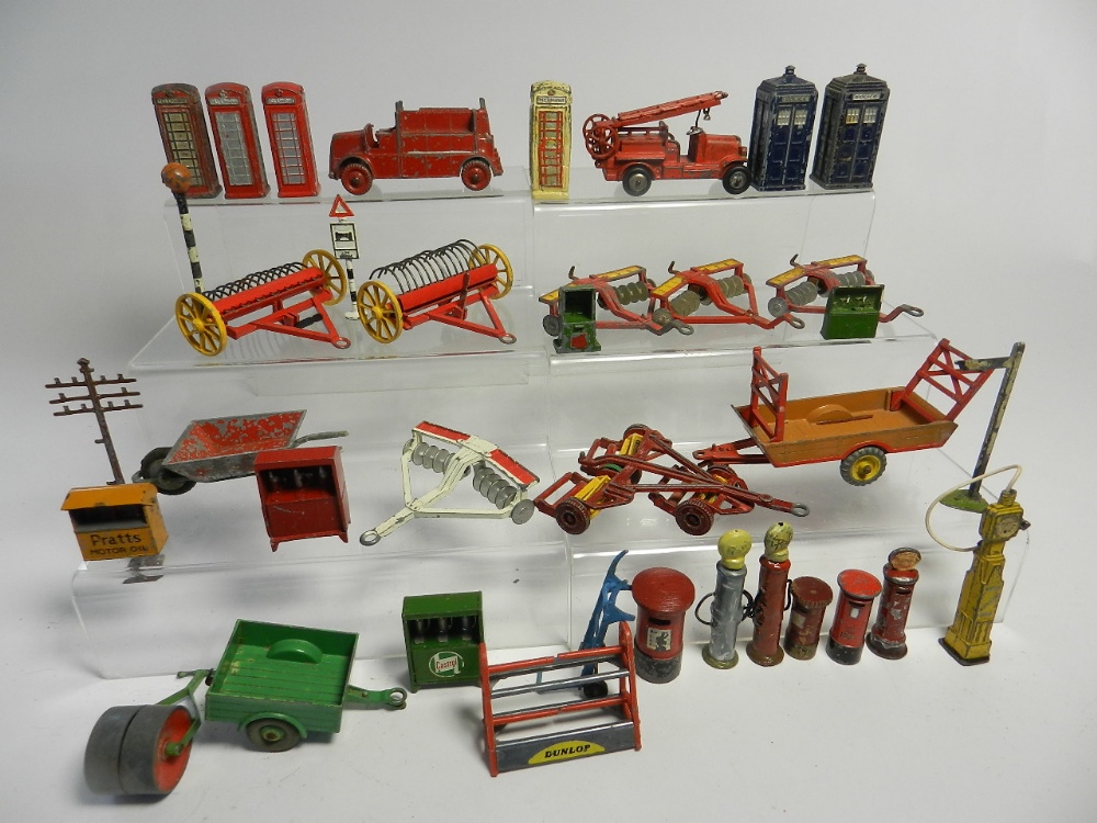 A collection of die cast accessories by Dinky and other makers to include hay rakes, harrows,