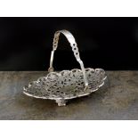A Chinese white metal pierced bon bon basket, with floral decoration,