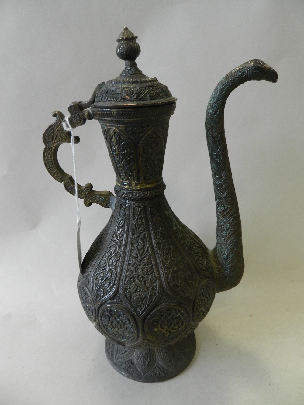 An Islamic bronze repousse ewer, 19th Century, - Image 2 of 2