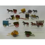 Eleven horse drawn carts and hand carts in lead by Britains, Charbens, Morestone and others,