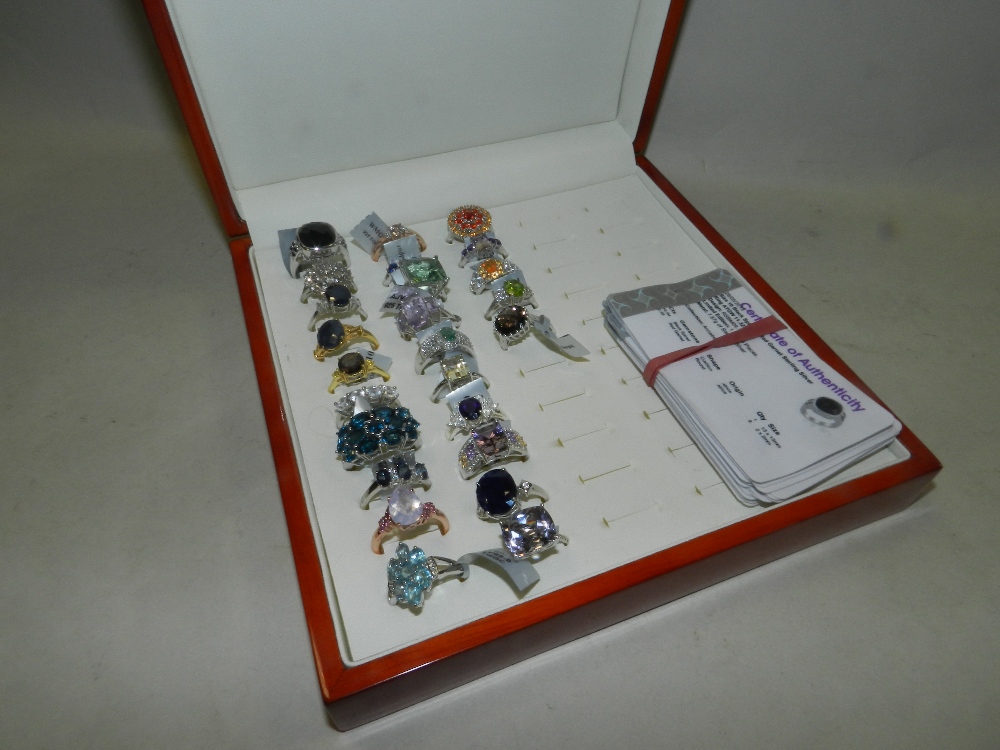 A collection of 25 silver and silver gilt stone set dress rings to include a black spinel and red