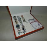 A collection of 25 silver and silver gilt stone set dress rings to include a black spinel and red