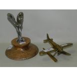 A mounted 'Spirit of Ecstasy' Rolls-Royce car mascot on wooden base together with a brass Art Deco
