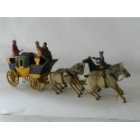 A hand made wooden carved model of a stagecoach and four horses with driver,